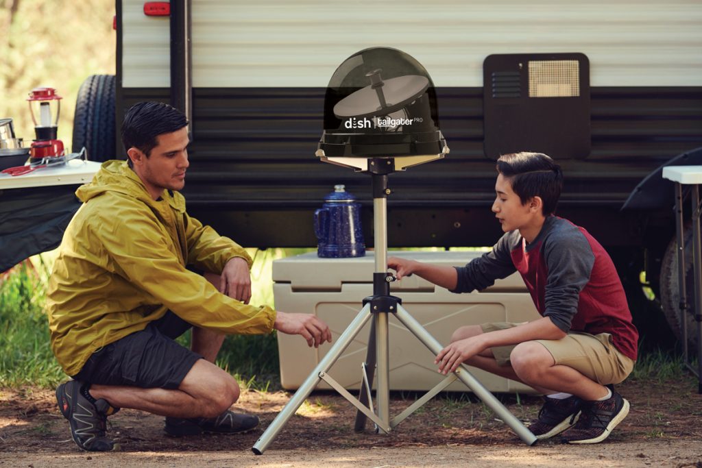 Father and son setting up dish tailgater