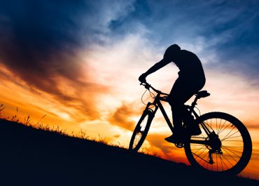 Man riding a bike up a hill