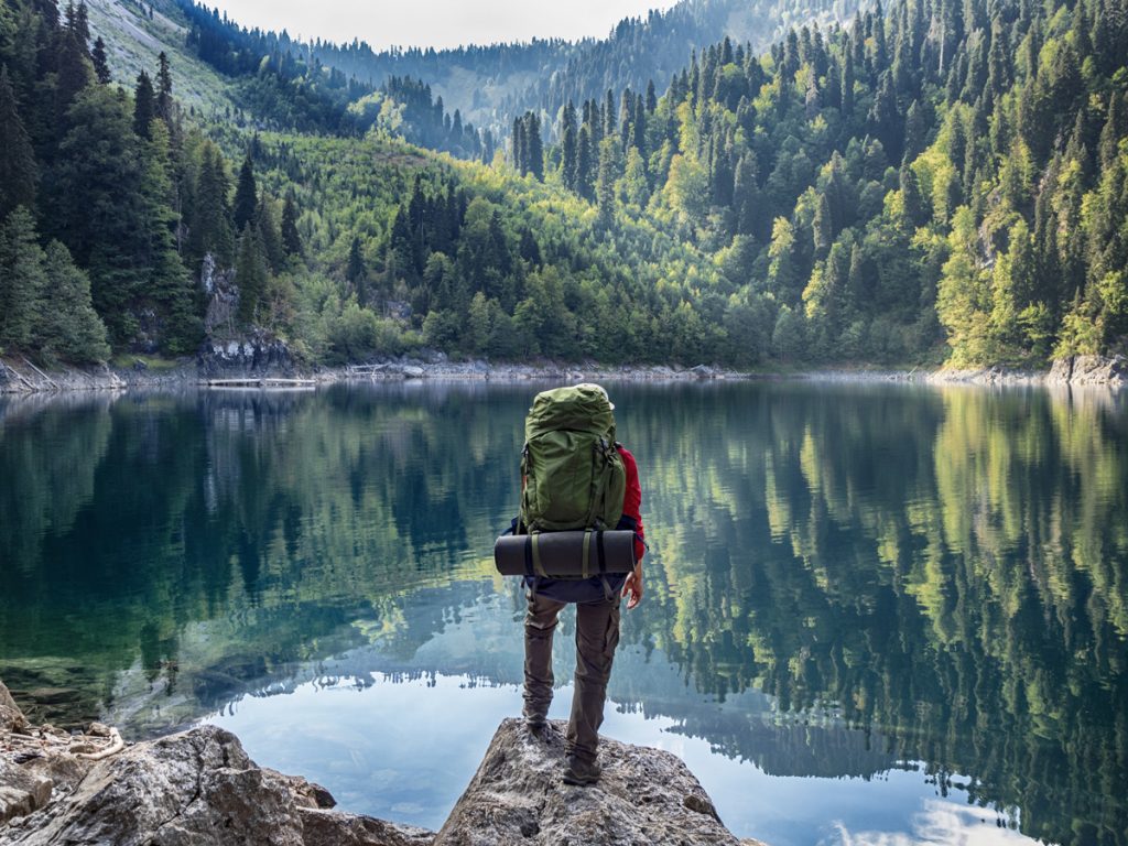 Backpacker looking over a lake