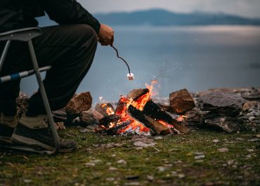 Man cooking a marshmallow over a fire