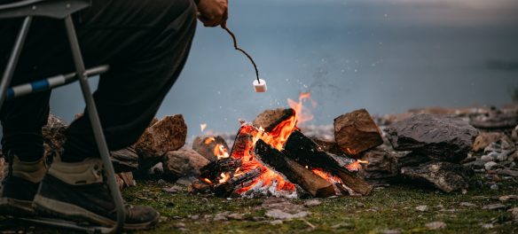 Man cooking a marshmallow over a fire