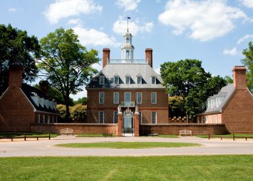 The Governor's Palace in Colonial Williamsburg, Virginia. A brick Colonial house with a courtyard, and former home of Thomas Jefferson.