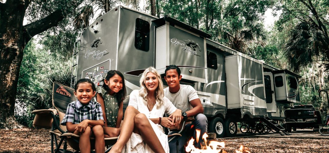 Family sitting in front of RV