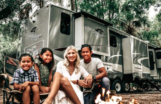 Family sitting in front of RV