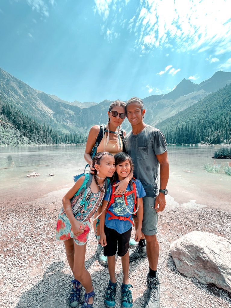 The Axness family in front of a lake and mountains