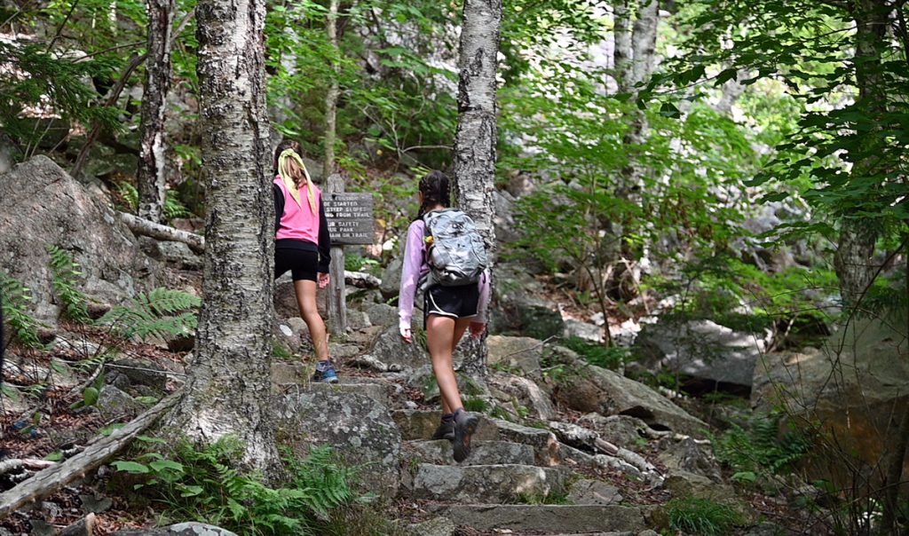 Two girls hiking on a trail